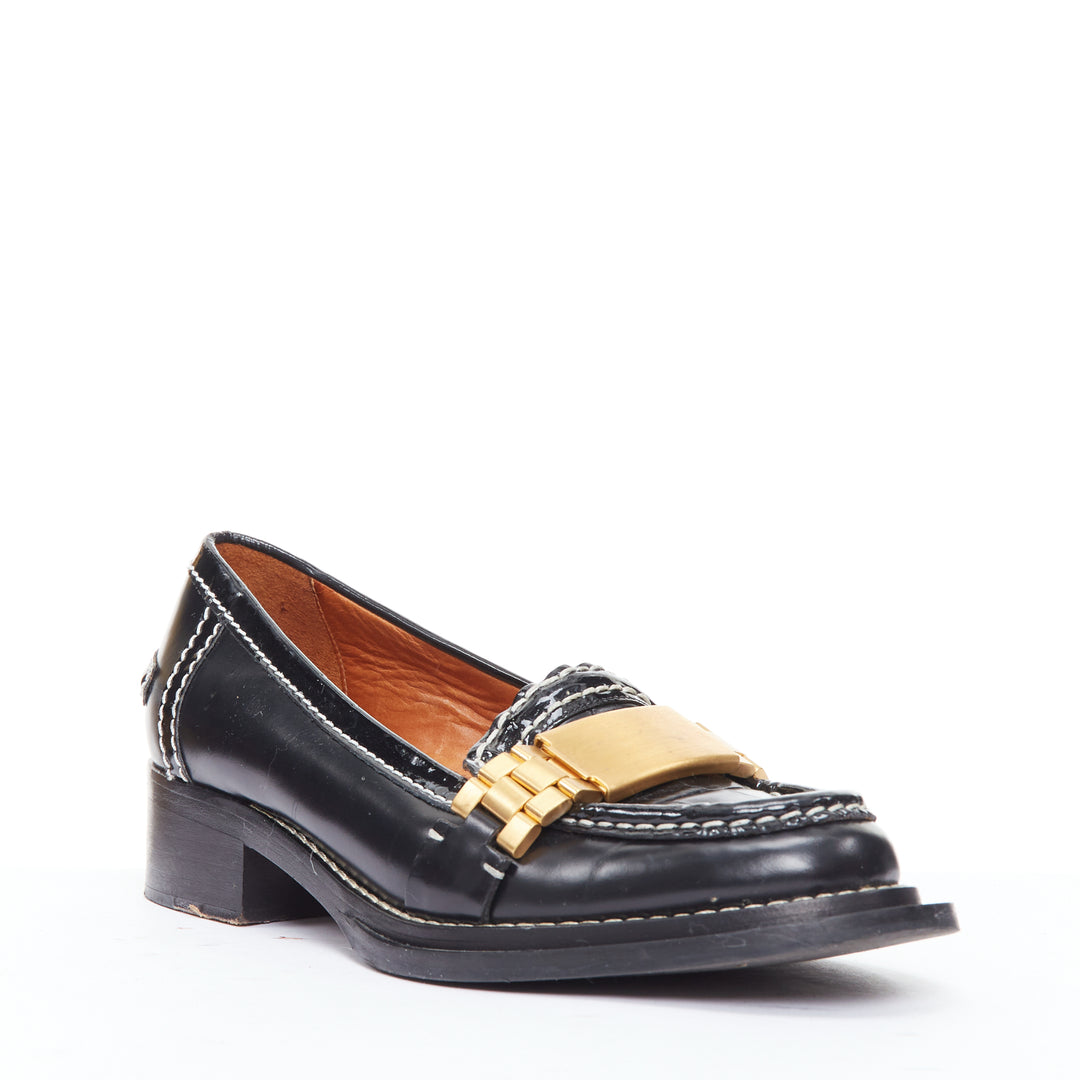 Female mannequin wearing Acne Studios Penny Watch Black Leather Women Flats in Size EU38 | Available at JHROP