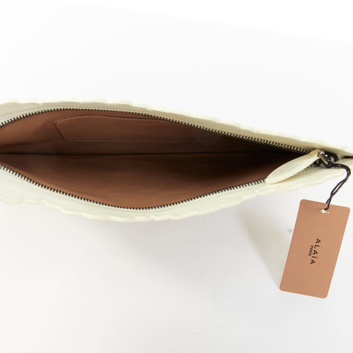 ALAIA Vienne laser cut white leather black lined scalloped zip pouch clutch bag