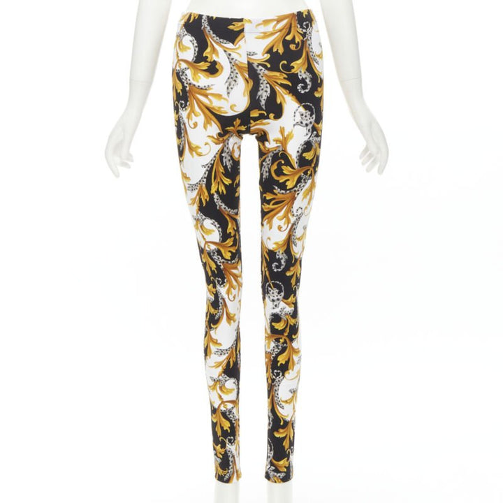 Female mannequin wearing Versace by Donatella Versace Barocco Acanthus Gold Polyamide Women Pants in Size IT42 | Available at JHROP