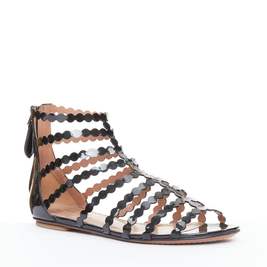 ALAIA black patent leather laser cut scalloped cage gladiator flat sandals EU36