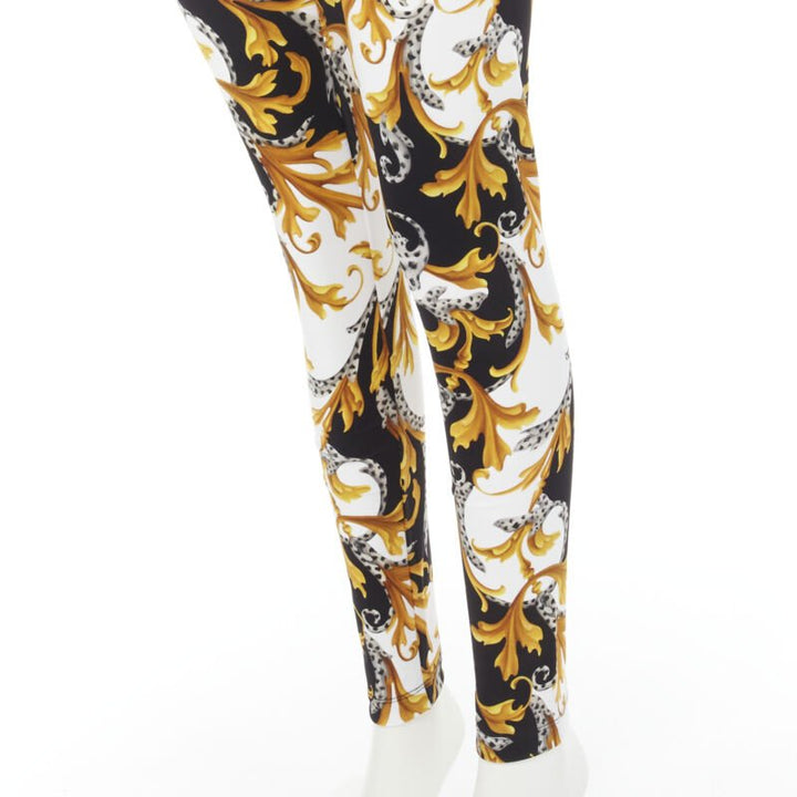 Female mannequin wearing Versace by Donatella Versace Barocco Acanthus Gold Polyamide Women Pants in Size IT42 | Available at JHROP