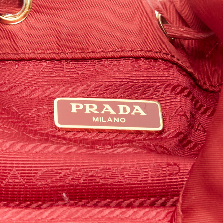 Female mannequin wearing Prada by Miuccia Prada Red Nylon Women Bag in Size  | Available at JHROP