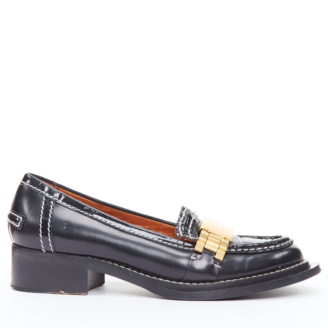 Female mannequin wearing Acne Studios Penny Watch Black Leather Women Flats in Size EU38 | Available at JHROP