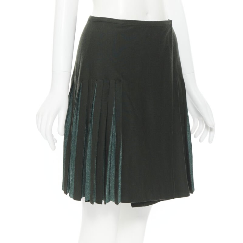 Female mannequin wearing Alaia by Azzedine Alaia Pleated flared wrap skirt Green Wool Women Skirt in Size FR40 | Available at JHROP