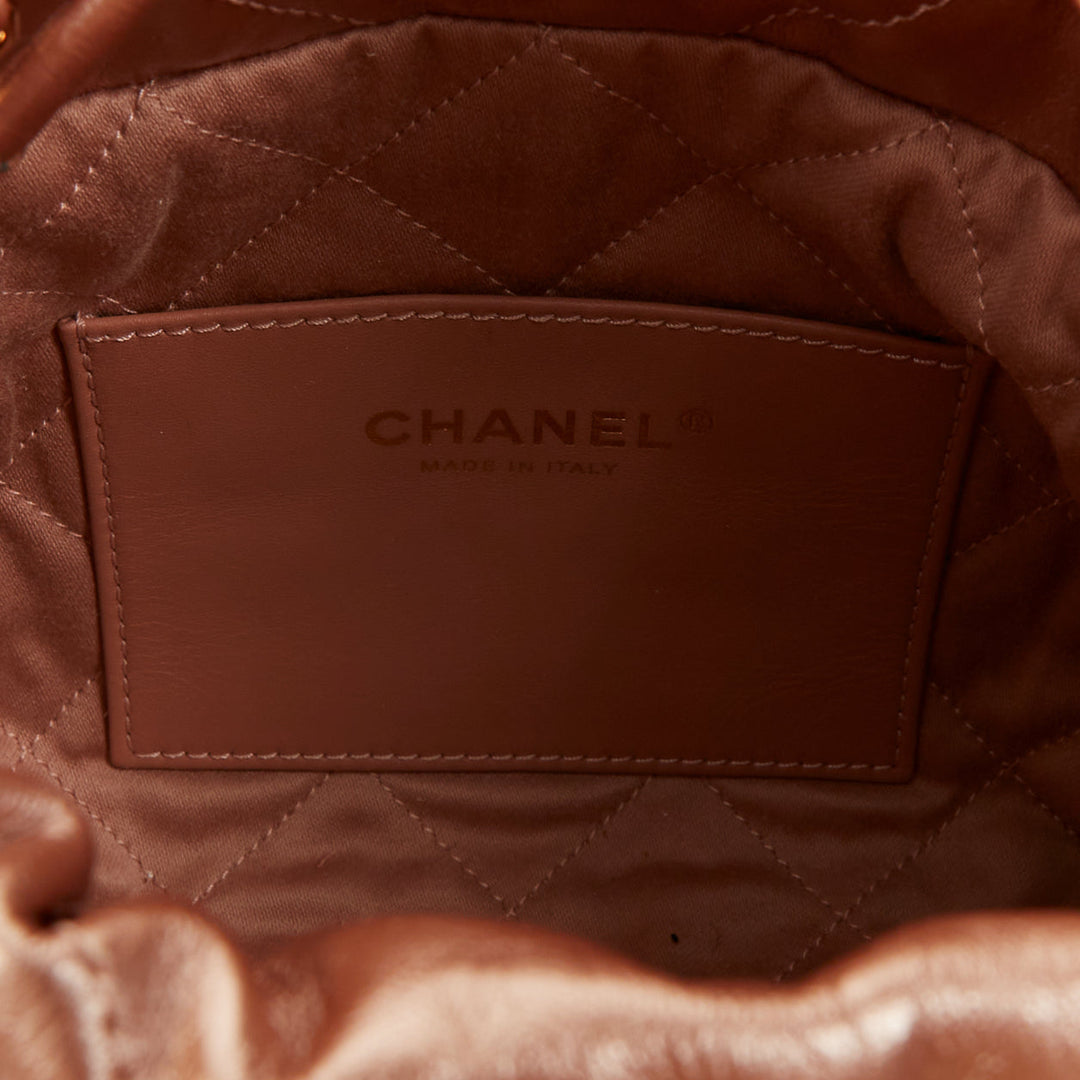 CHANEL 2023 Runway 22 Mini rose gold metallic calfskin leather drawstring bag