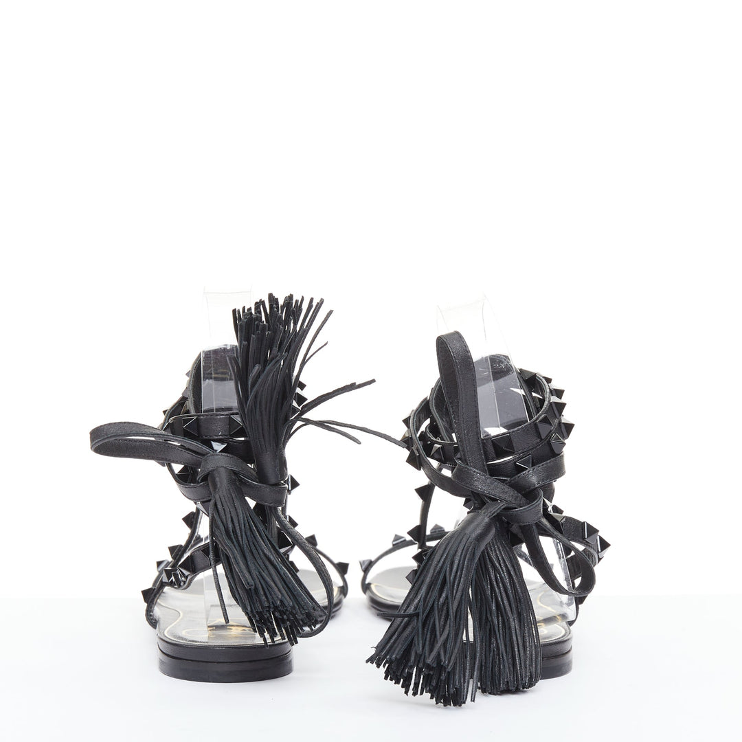 VALENTINO Rockstud black leather wraparound lace up tassel gladiator flats EU38