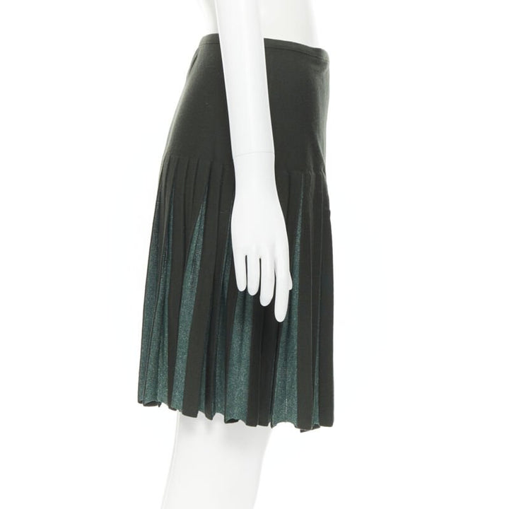 Female mannequin wearing Alaia by Azzedine Alaia Pleated flared wrap skirt Green Wool Women Skirt in Size FR40 | Available at JHROP