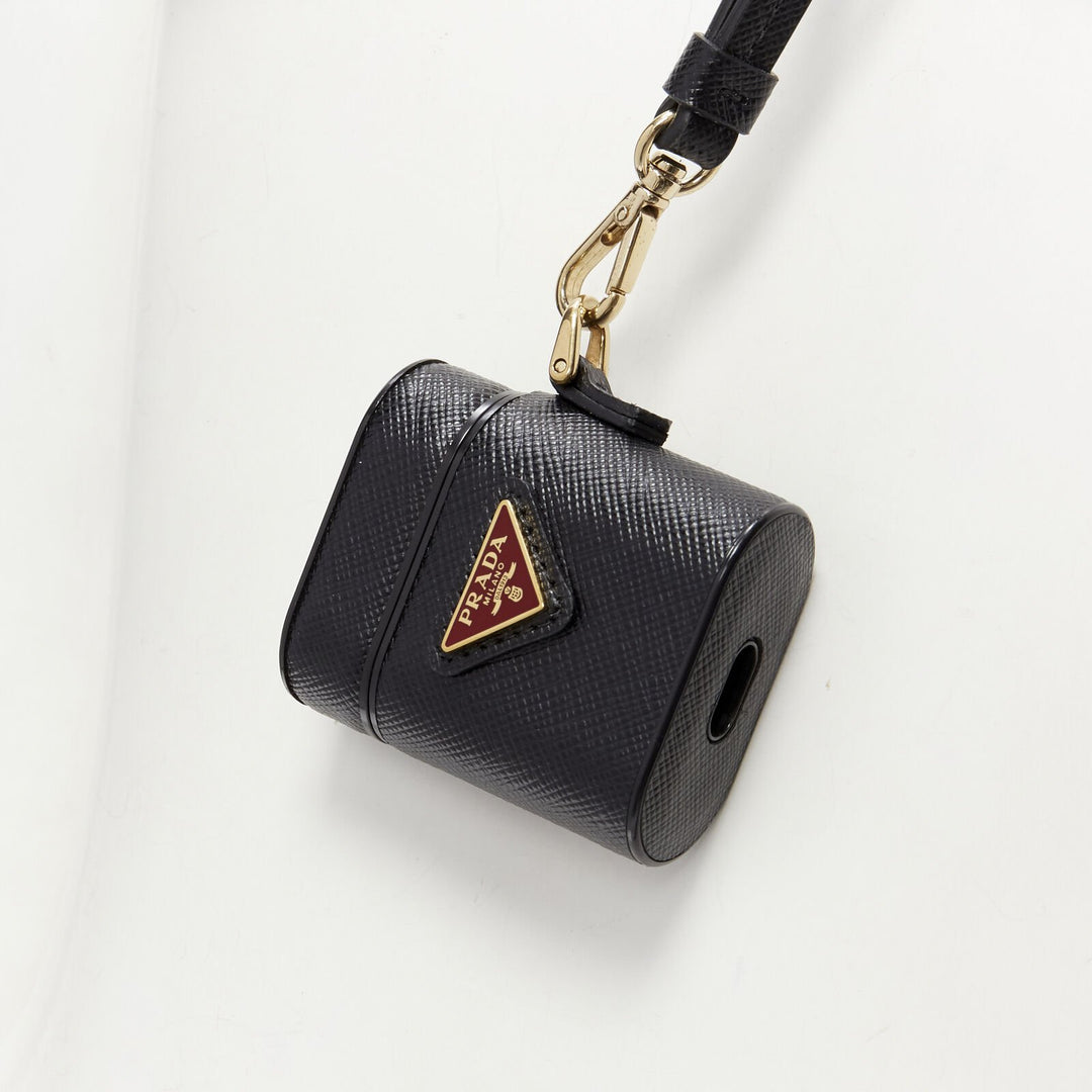  mannequin wearing Prada by Miuccia Prada AirPods case Black Leather Key Chain in Size  | Available at JHROP