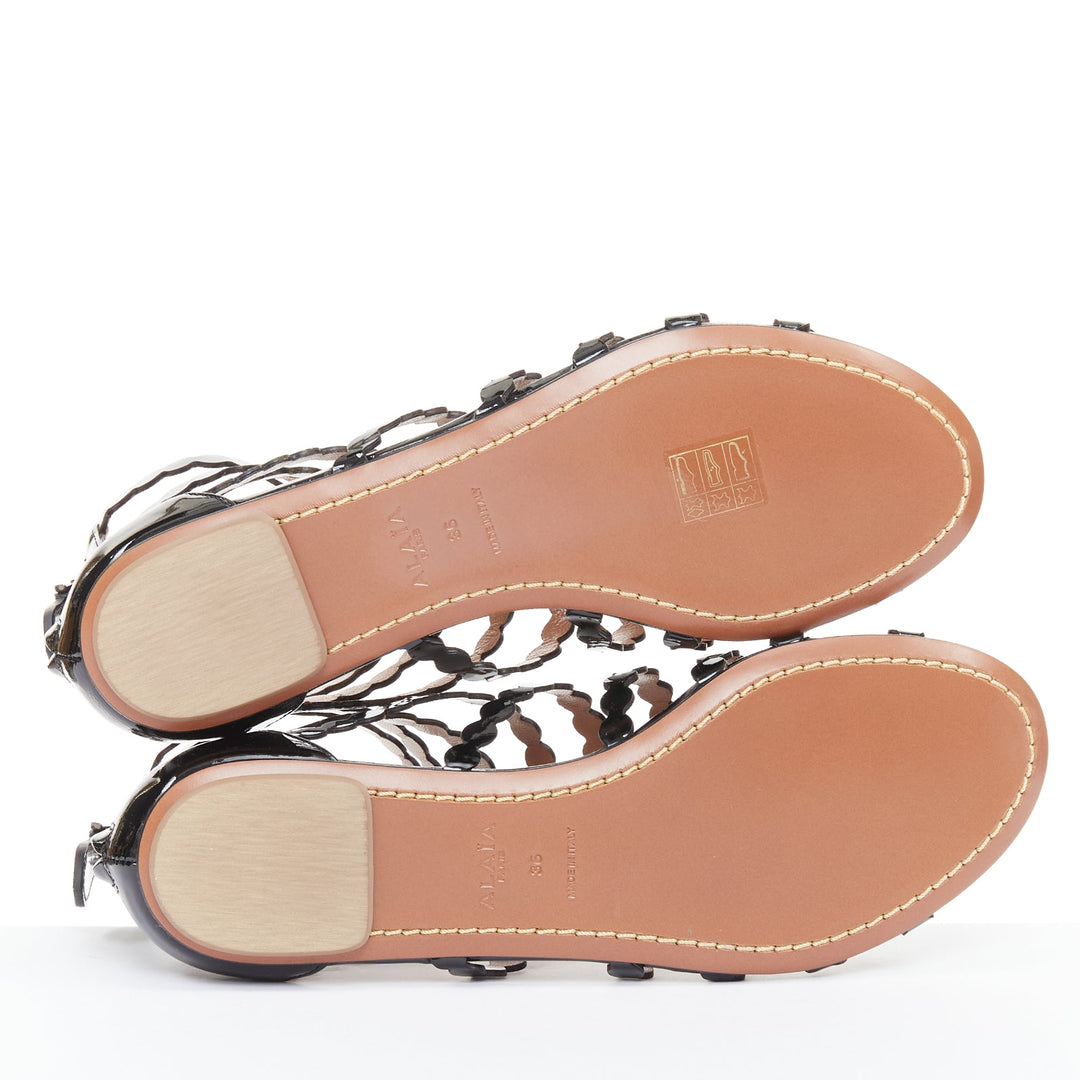 ALAIA black patent leather laser cut scalloped cage gladiator flat sandals EU36