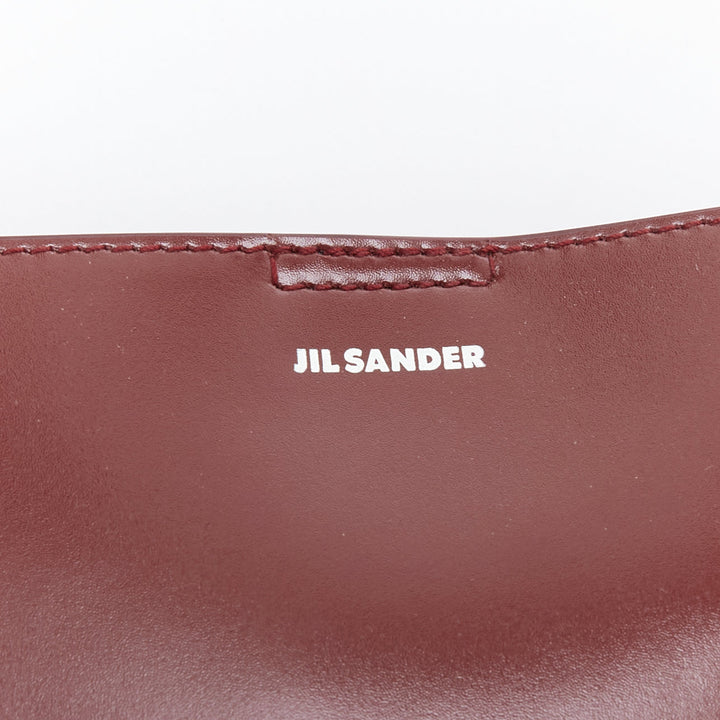 JIL SANDER Tangle burgundy knotted leather strap medium crossbody bag