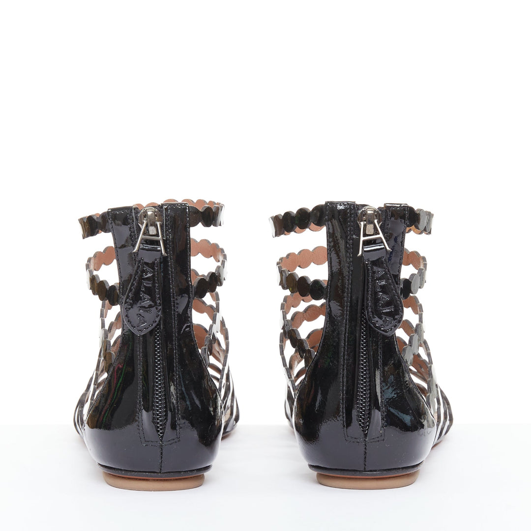 ALAIA black patent leather laser cut scalloped cage gladiator flat sandals EU36