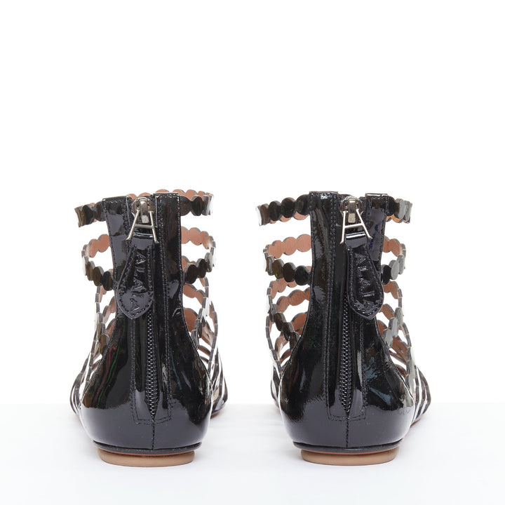 ALAIA black patent leather laser cut scalloped cage gladiator flat sandals EU36