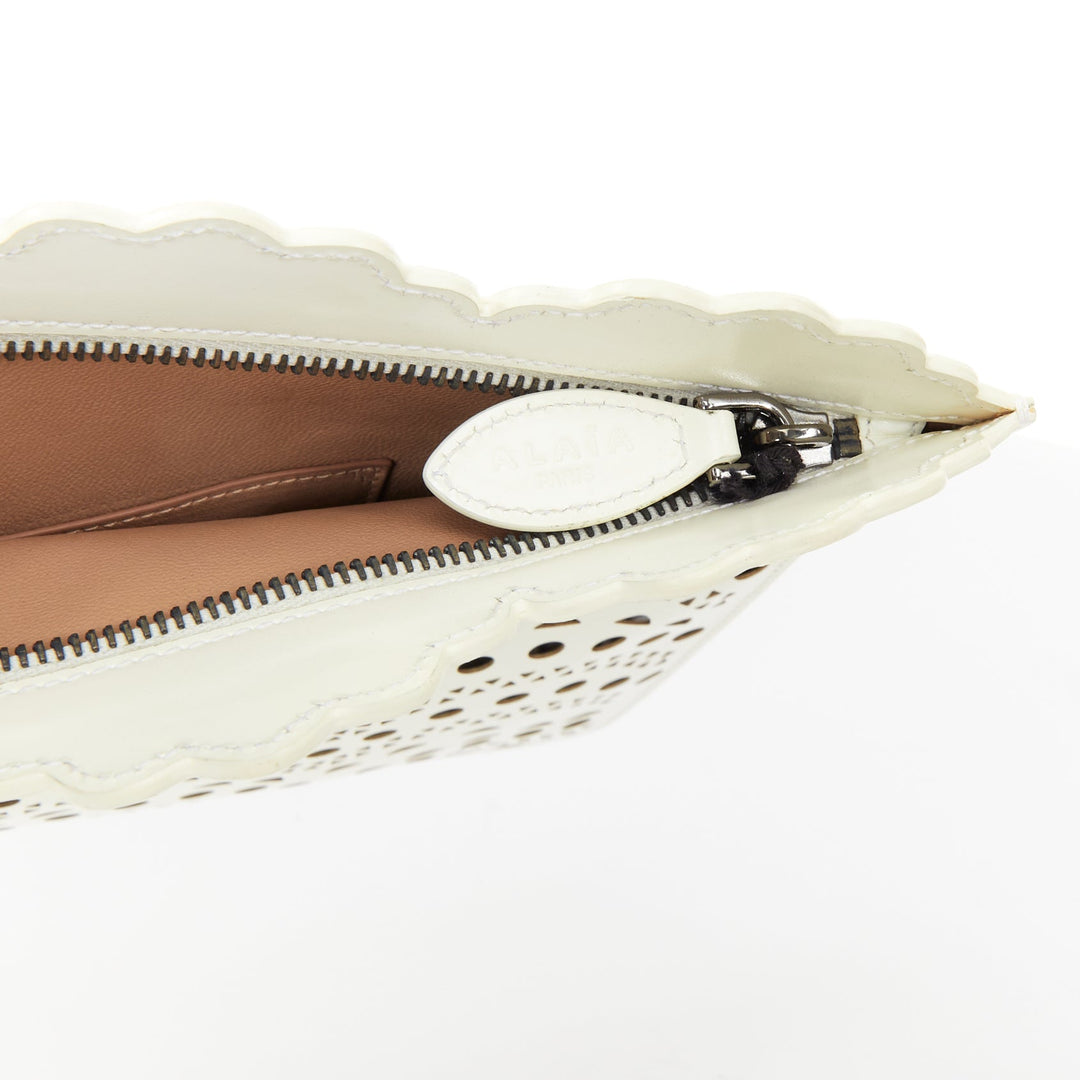 ALAIA Vienne laser cut white leather black lined scalloped zip pouch clutch bag