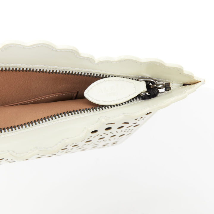 ALAIA Vienne laser cut white leather black lined scalloped zip pouch clutch bag