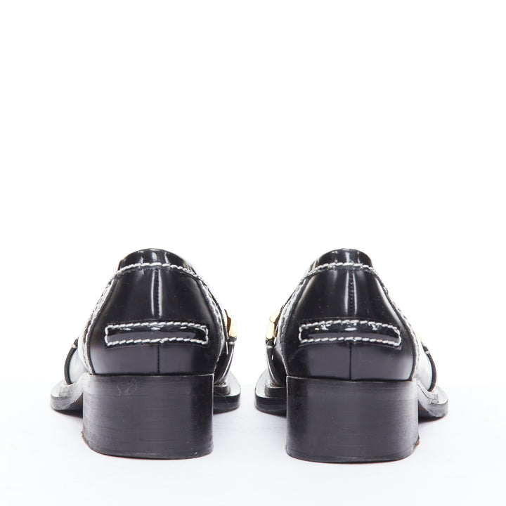 Female mannequin wearing Acne Studios Penny Watch Black Leather Women Flats in Size EU38 | Available at JHROP