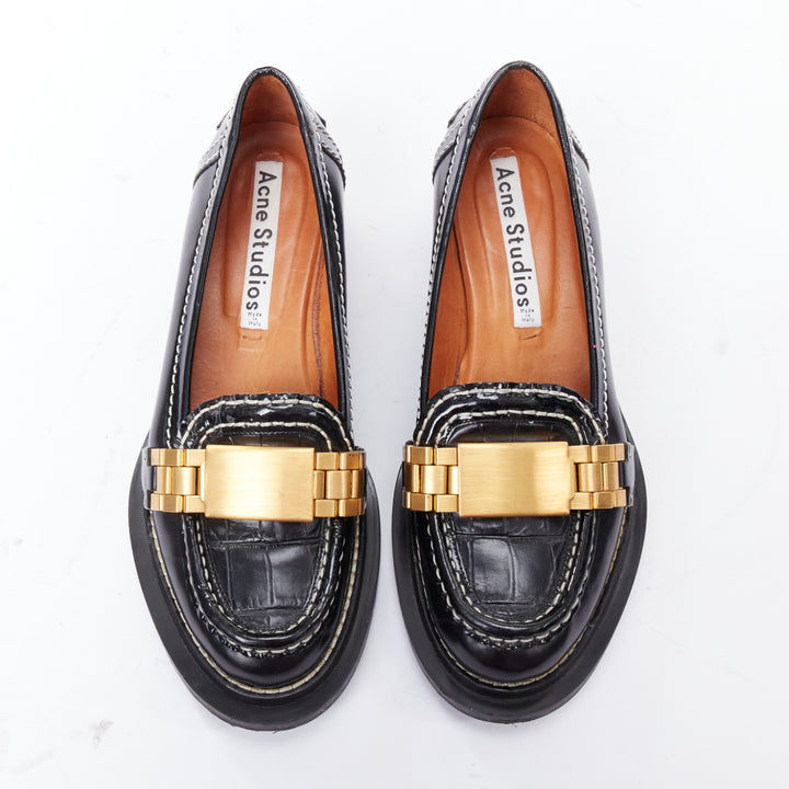 Female mannequin wearing Acne Studios Penny Watch Black Leather Women Flats in Size EU38 | Available at JHROP