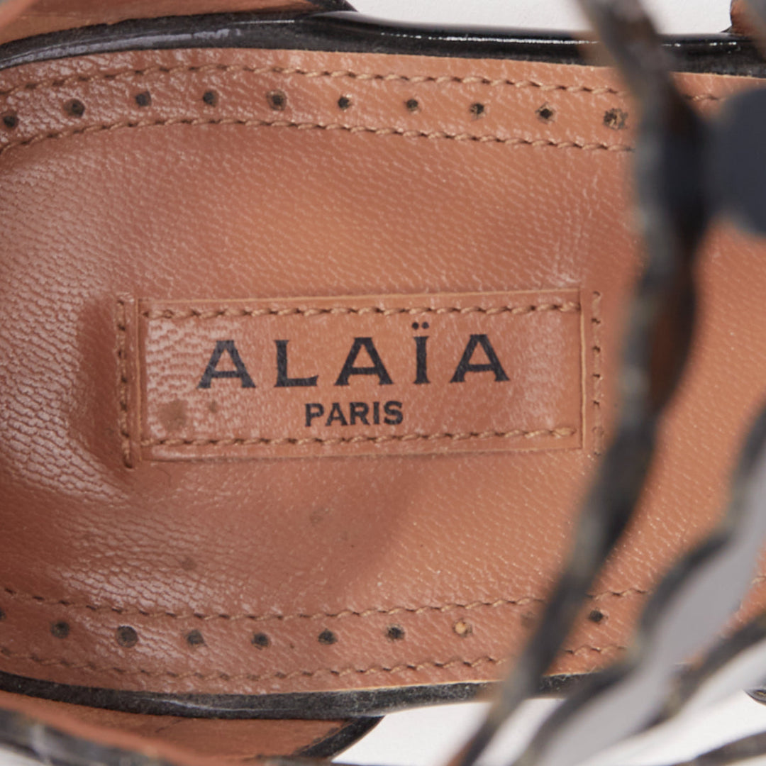 ALAIA black patent leather laser cut scalloped cage gladiator flat sandals EU36