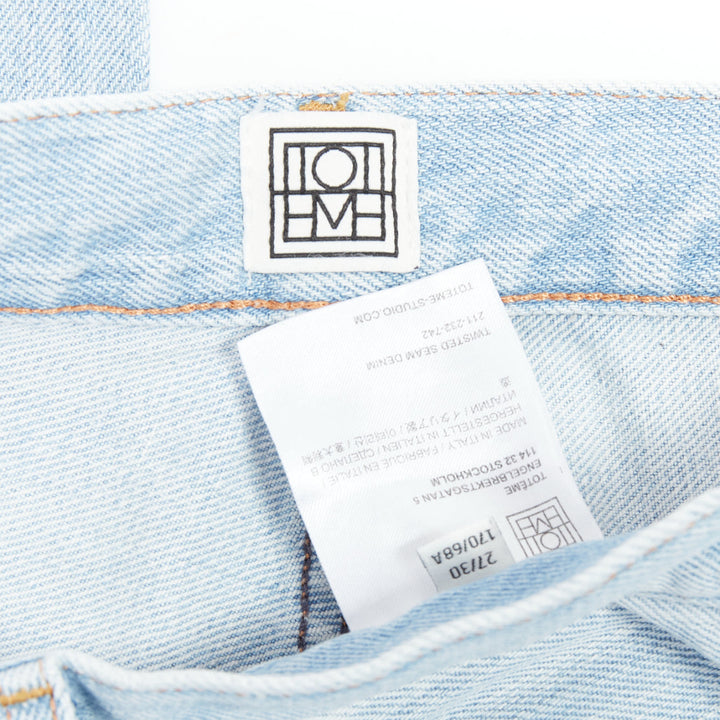 TOTEME Twisted Seam light blue washed denim asymmetric jeans 27"