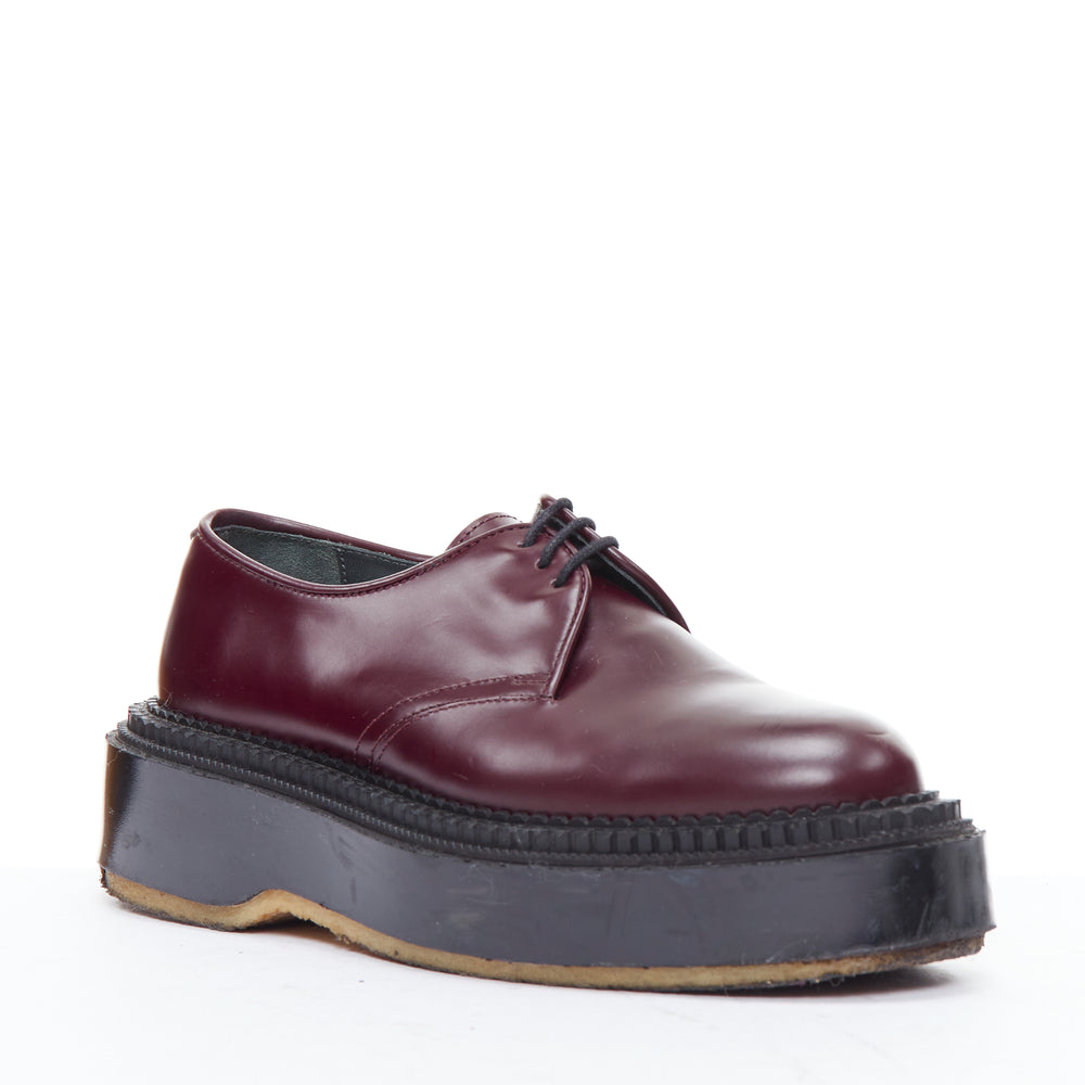 Female mannequin wearing Undercover FW 2018 Adieu Paris Burgundy Leather Women Flats in Size EU38 | Available at JHROP