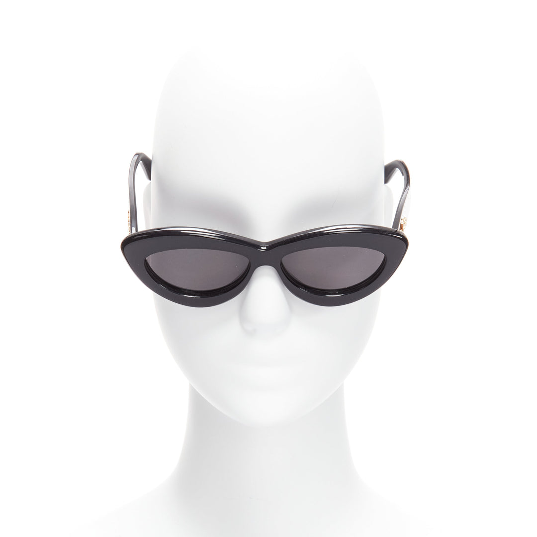 Female mannequin wearing Loewe by JW Anderson LW400961 Black Acetate Women Sunglasses in Size  | Available at JHROP