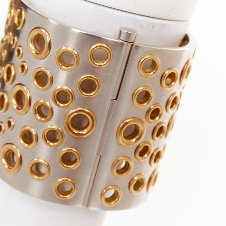 CHANEL B16 silver tone gold CC logo punctured grommet eyelet cuff bangle