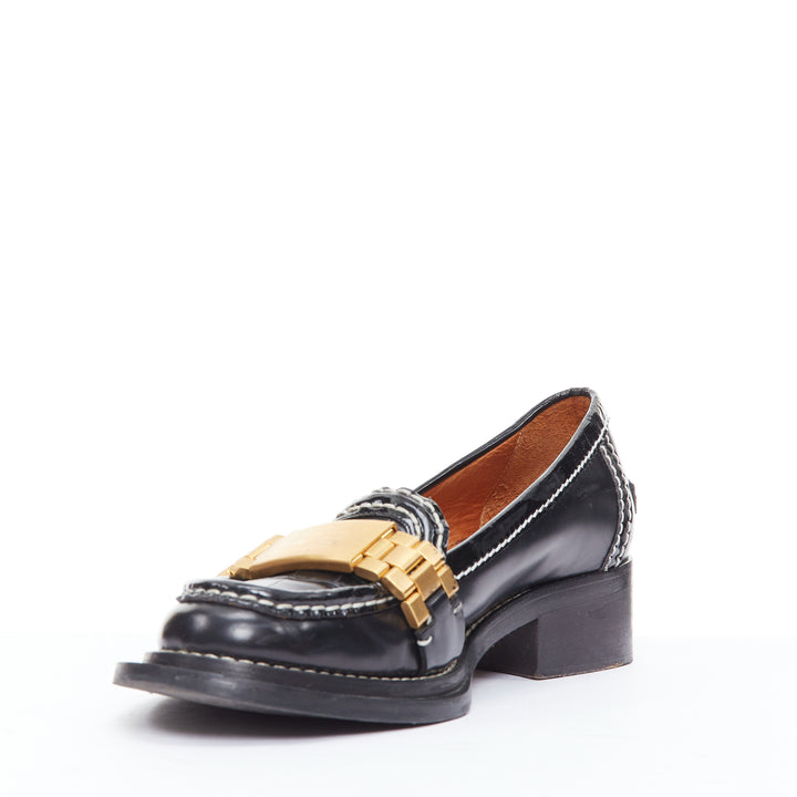 Female mannequin wearing Acne Studios Penny Watch Black Leather Women Flats in Size EU38 | Available at JHROP