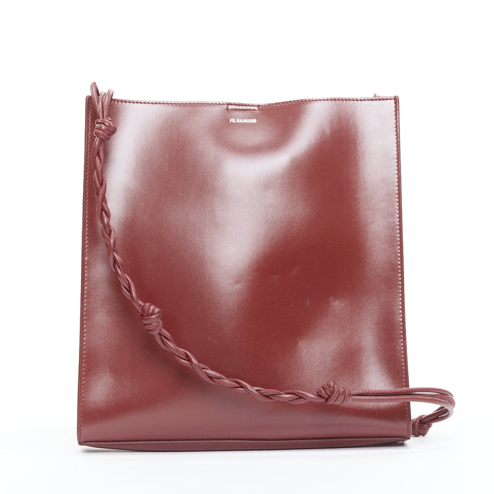 JIL SANDER Tangle burgundy knotted leather strap medium crossbody bag