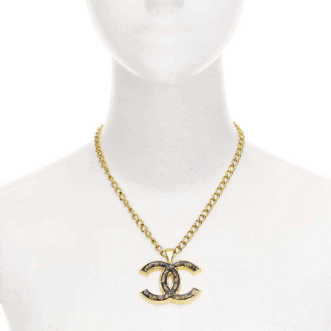CHANEL 2023 Monte Carlo gold black glitter foil resin CC logo pendant  necklace