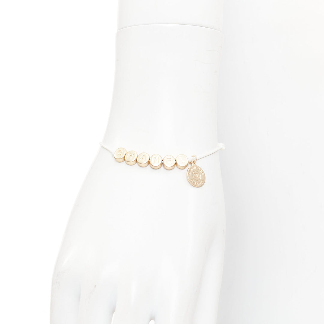 CHANEL white gold tone logo letter bead charm white thread lucky bracelet