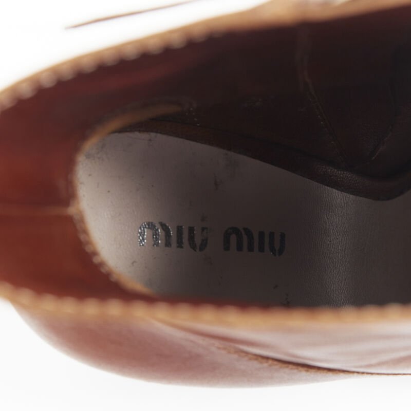 Female mannequin wearing Miu Miu by Miuccia Prada Peep toe bootie Brown Leather Women Heels in Size EU37.5 | Available at JHROP