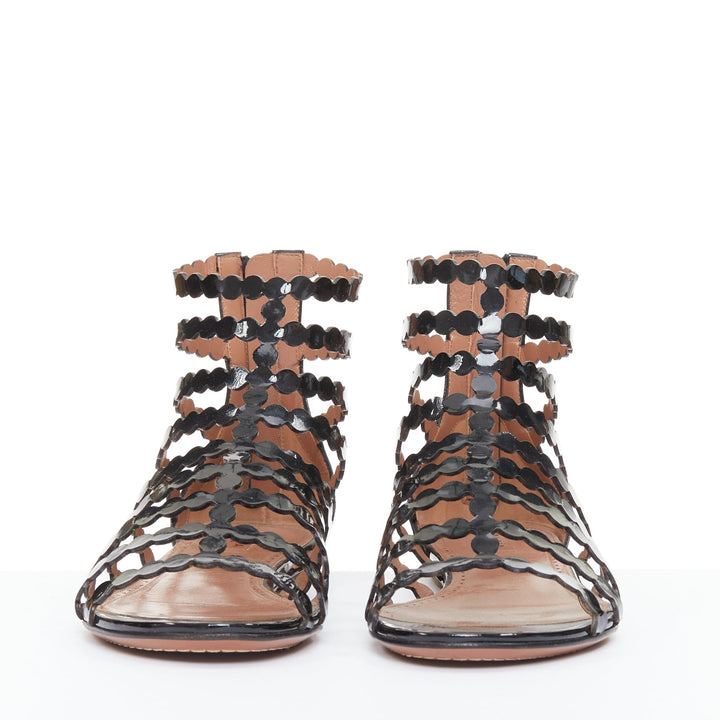 ALAIA black patent leather laser cut scalloped cage gladiator flat sandals EU36