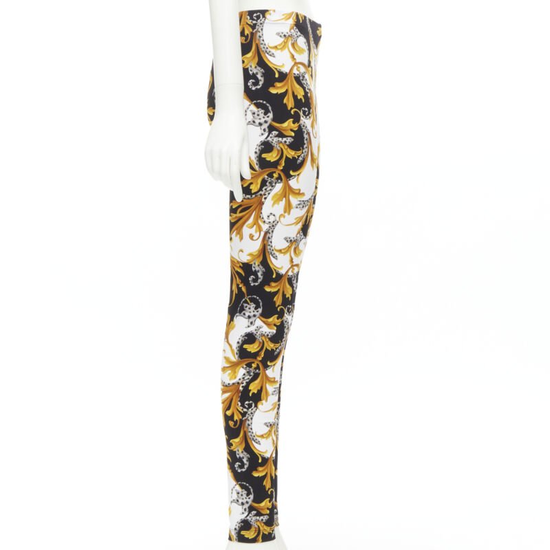 Female mannequin wearing Versace by Donatella Versace Barocco Acanthus Gold Polyamide Women Pants in Size IT42 | Available at JHROP