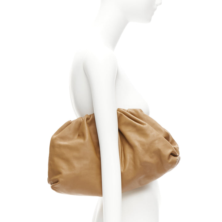 Female mannequin wearing Bottega Veneta by Daniel Lee The Pouch Brown Leather Women Bag in Size  | Available at JHROP