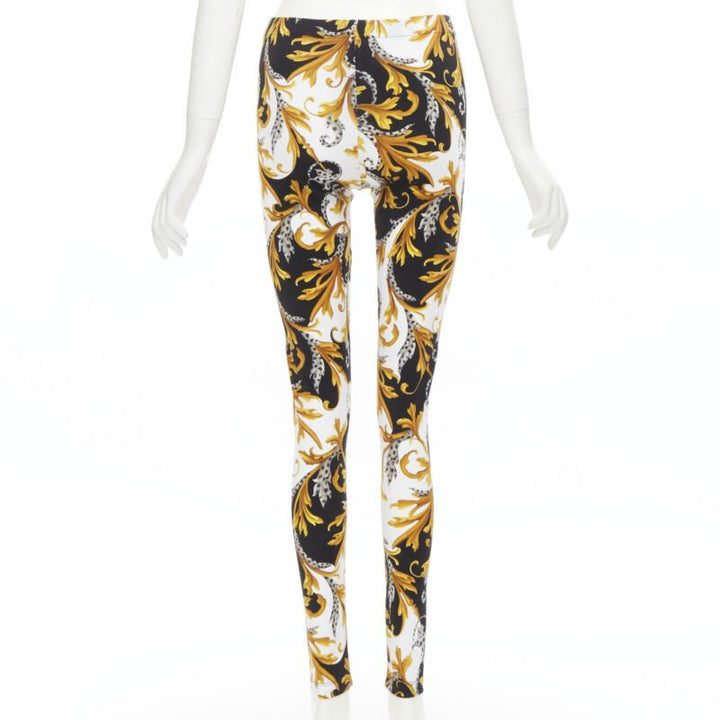 Female mannequin wearing Versace by Donatella Versace Barocco Acanthus Gold Polyamide Women Pants in Size IT42 | Available at JHROP