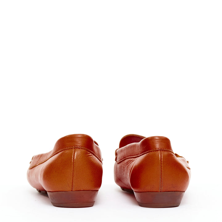SALVATORE FERRAGAMO burnt orange leather gold logo buckle loafers 6.5