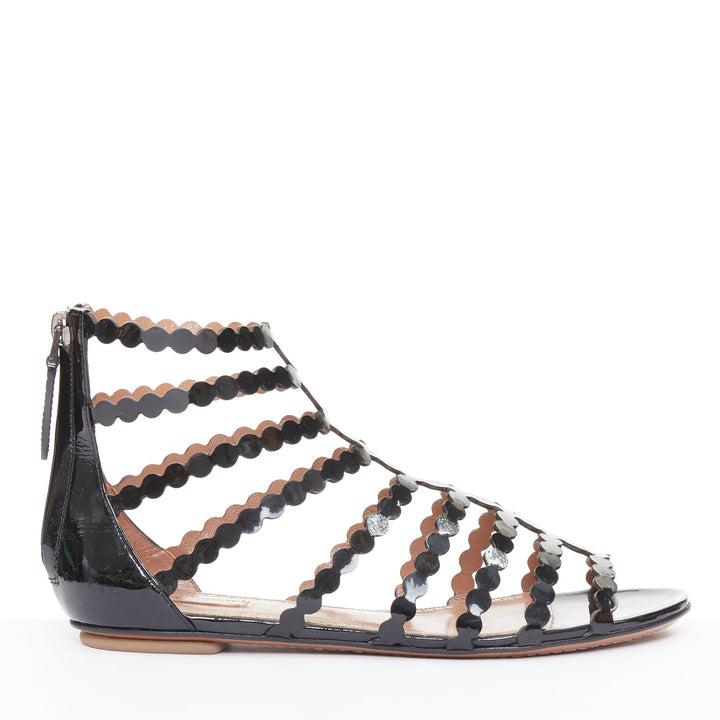 ALAIA black patent leather laser cut scalloped cage gladiator flat sandals EU36