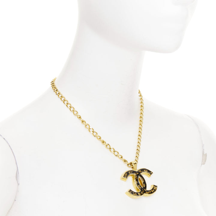 CHANEL 2023 Monte Carlo gold black glitter foil resin CC logo pendant  necklace